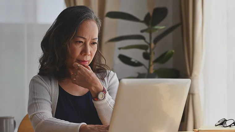 Employer at desk, contemplating weather they need employee perks and benefits tech